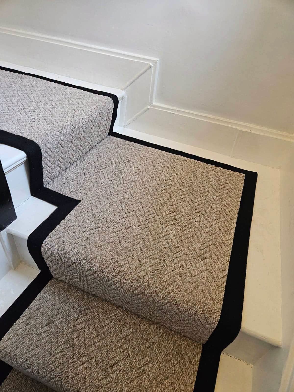Herringbone stair runner with black bound edges fitted by BDL Carpets & Vinyl in Sheffield